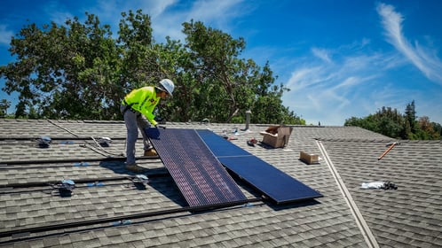 Citadel installer placing a solar panel on a roof