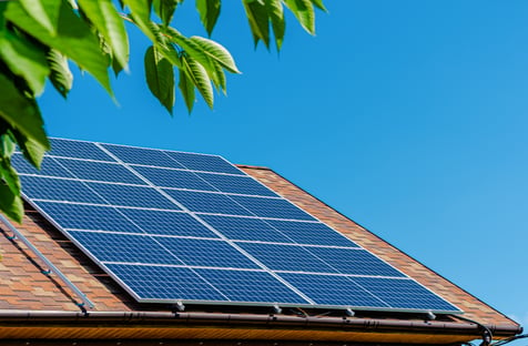 solar panels on a roof with a clear blue sky in the background